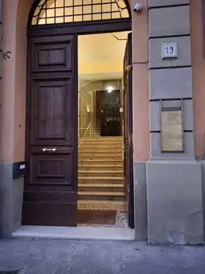 an entrance to a building with a wooden door and stairs at Breathe Romance San Giovanni in Rome