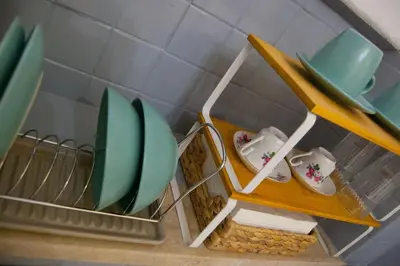 a shelf with plates and shoes in a kitchen at Breathe Romance San Giovanni in Rome