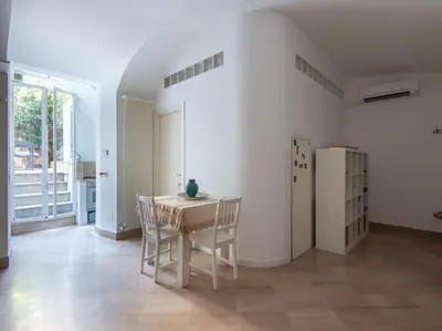 a dining room with a table and chairs and a refrigerator at Central Station Enchanting Apartments in Rome
