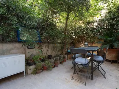 a patio with a table and chairs and plants at Central Station Enchanting Apartments in Rome