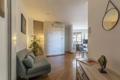 a living room with a couch and a mirror at HospitalityRome Nice Apartment in Rome