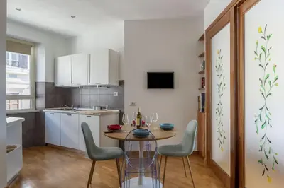 a kitchen with a table and chairs in a room at HospitalityRome Nice Apartment in Rome