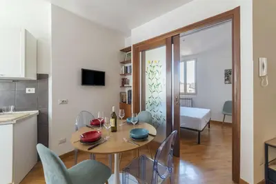 a kitchen and dining room with a table and chairs at HospitalityRome Nice Apartment in Rome