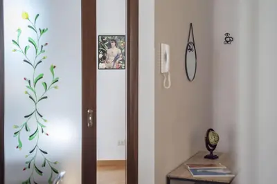a hallway with a door with a picture on the wall at HospitalityRome Nice Apartment in Rome