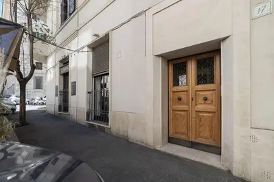 a building with a wooden door on a street at HospitalityRome Nice Apartment in Rome