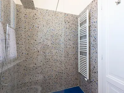 a bathroom with a shower and a toilet and a window at Vatican Luxury Apartment in Rome