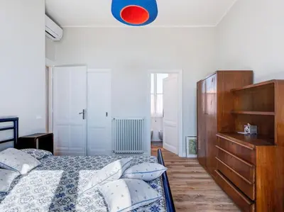 a bedroom with a bed and a dresser in it at Vatican Luxury Apartment in Rome