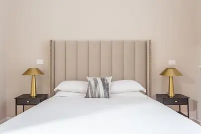 a white bedroom with a white bed and a window at Daplace - Allegra Apartment in Rome