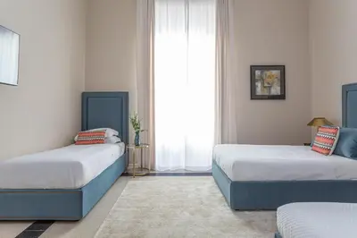 a white bathroom with a sink and a toilet at Daplace - Allegra Apartment in Rome