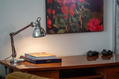 a desk with a lamp and books on it at Esquilino Dream in Rome