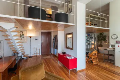 a living room and dining room with a spiral staircase at Esquilino Dream in Rome