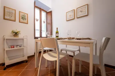 a dining room with a table and chairs at RomAntica Bocca della Verità in Rome