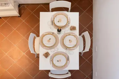 a set of plates on a table in a kitchen at RomAntica Bocca della Verità in Rome