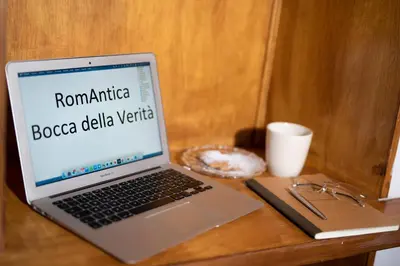 a laptop computer sitting on top of a wooden table at RomAntica Bocca della Verità in Rome