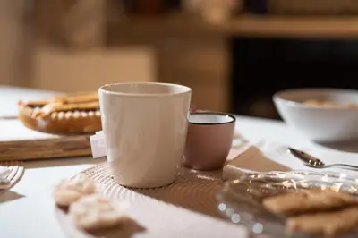 a table with a cup of coffee and some cookies at RomAntica Bocca della Verità in Rome