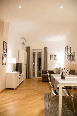 a living room with a couch and a table at Nerhome Vatican Suite in Rome