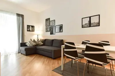a living room with a couch and a table and chairs at Nerhome Vatican Suite in Rome