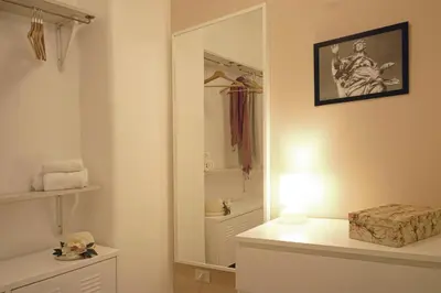 a bathroom with a mirror and a light on a counter at Nerhome Vatican Suite in Rome