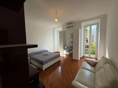 a living room with a bed and a couch at Casa Gigi al Vaticano in Rome