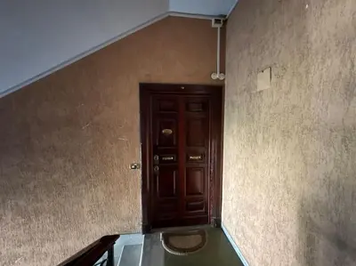 a hallway with a wooden door in a room at Casa Gigi al Vaticano in Rome