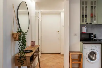 a laundry room with a mirror and a washing machine at GuestHost - Lungotevere central and bright apartment in Rome