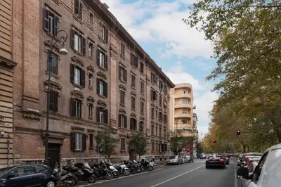a row of motorcycles parked on a street next to buildings at GuestHost - Lungotevere central and bright apartment in Rome