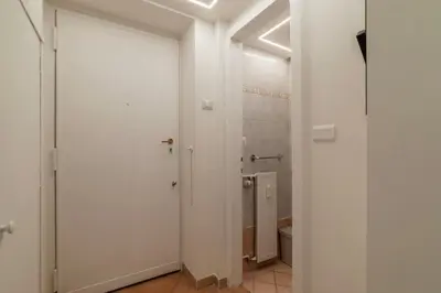 a white bathroom with a toilet and a shower at GuestHost - Lungotevere central and bright apartment in Rome