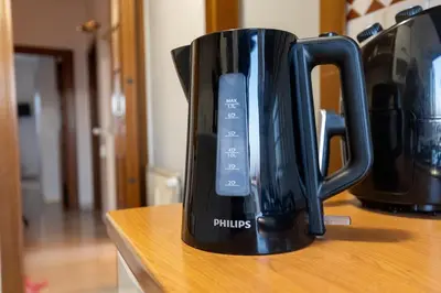 a black coffee cup with a remote control in it at Eur-motagnola attico 2bedr apt 280 terrace view in Rome