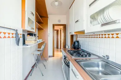 a kitchen with a sink and a stove at Eur-motagnola attico 2bedr apt 280 terrace view in Rome