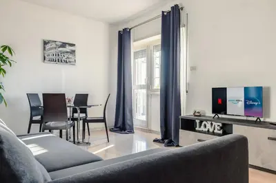 a living room with a couch and a tv at Eur-motagnola attico 2bedr apt 280 terrace view in Rome