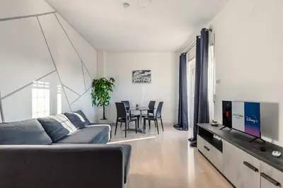 a living room with a couch and a tv and a table at Eur-motagnola attico 2bedr apt 280 terrace view in Rome