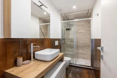 a bathroom with a white sink and a shower at Quattro Fontane 2P - B&D Apartments in Rome