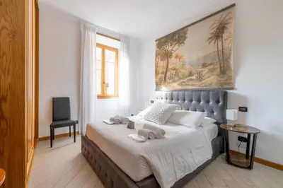 a bedroom with a large bed with towels on it at Quattro Fontane 2P - B&D Apartments in Rome