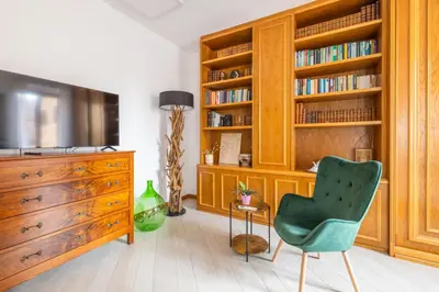 a living room with a dresser and a green chair at Quattro Fontane 2P - B&D Apartments in Rome