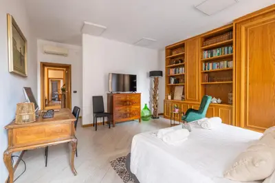 a bedroom with a bed and a desk and a desk at Quattro Fontane 2P - B&D Apartments in Rome