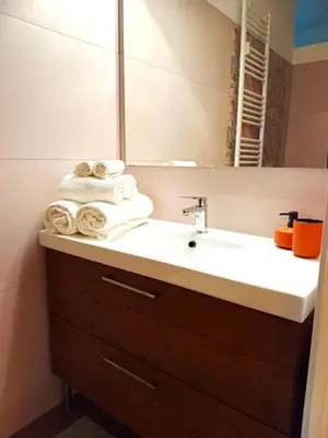 a bathroom with a sink with a mirror and towels at Soraya Home in Rome