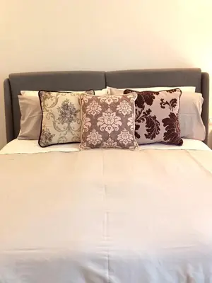 a bed with several pillows on top of it at Soraya Home in Rome