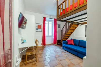 a living room with a blue couch and a staircase at CASA GIOVI - Apartment with garden in Rome