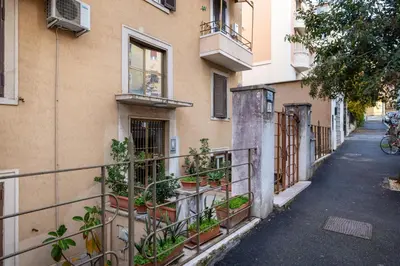 a building with potted plants on the side of it at CASA GIOVI - Apartment with garden in Rome