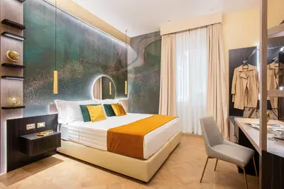 a bedroom with a bed and a desk and a chair at VentiSettembre Private Suites in Rome