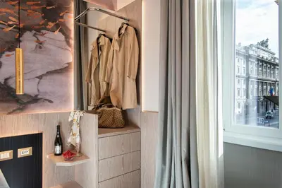 a room with a window and a coat rack at VentiSettembre Private Suites in Rome