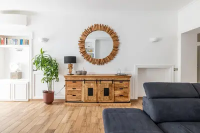 a living room with a couch and a mirror at Quattro Fontane 4P - B&D Apts in Rome