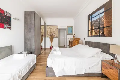 two beds in a room with white sheets at Quattro Fontane 4P - B&D Apts in Rome