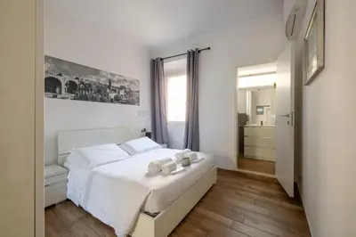 a bedroom with a white bed with towels on it at Quattro Fontane 4P - B&D Apts in Rome