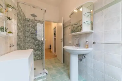 a bathroom with a sink and a shower at Trastevere - Monteverde Apartment in Rome