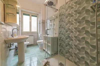 a bathroom with a sink and a toilet and a shower at Trastevere - Monteverde Apartment in Rome