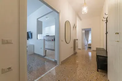 a hallway with a large glass door and a living room at Trastevere - Monteverde Apartment in Rome