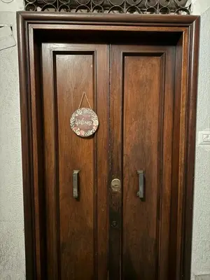 a wooden door with a sign on it at Scala Santa Home in Rome