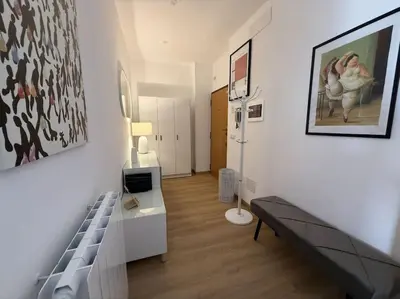 a room with a bed and a painting on the wall at Colosseo Licia Apartment in Rome