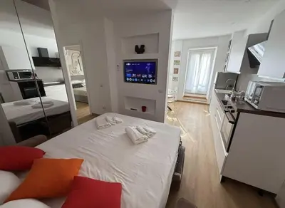 a small room with a bed and a kitchen at Colosseo Licia Apartment in Rome